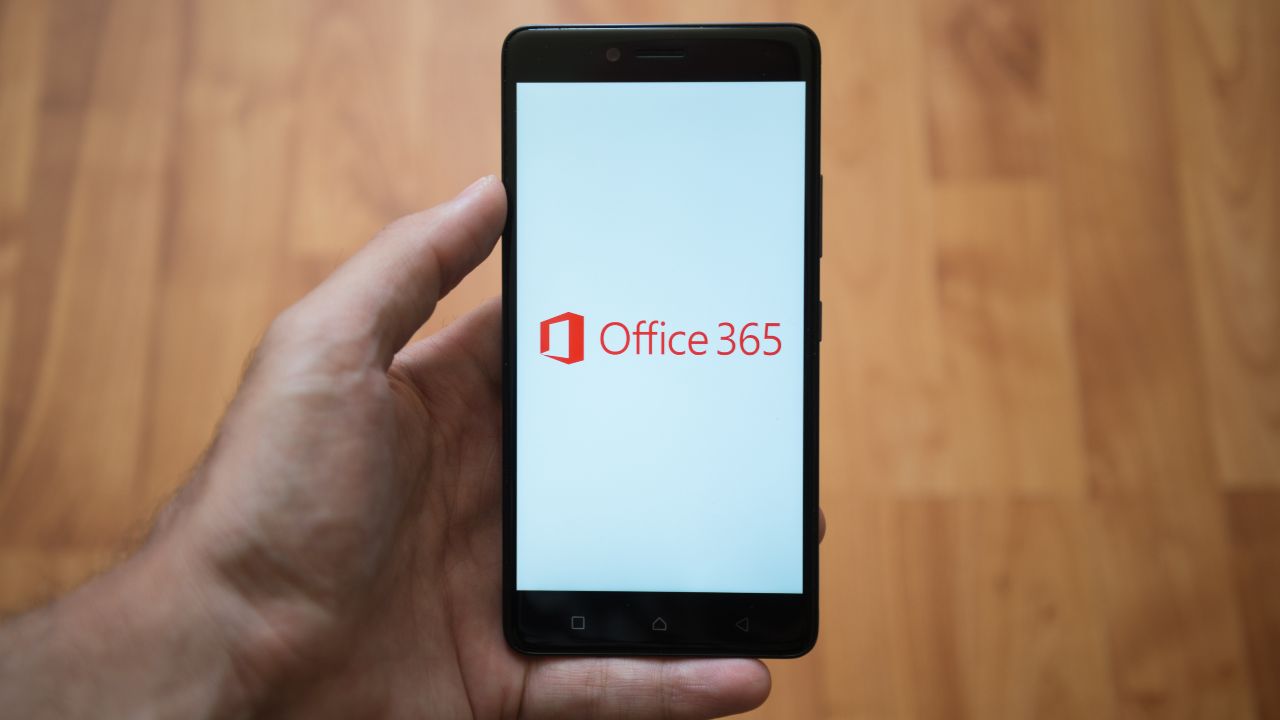 Microsoft 365, the solution to your online business needs. (MS Office 365 logo on phone)
